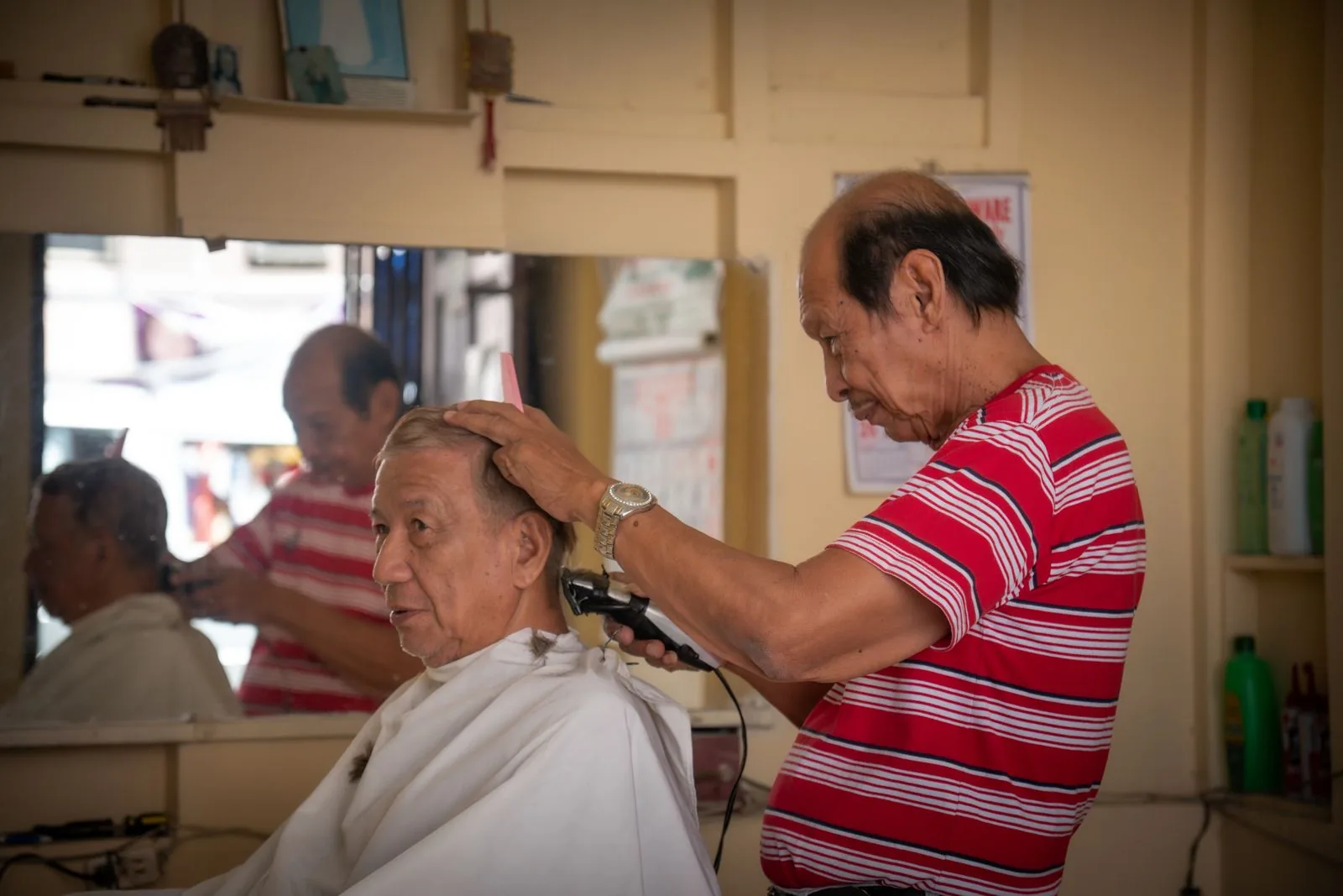 A barber giving a regular client his usual cut