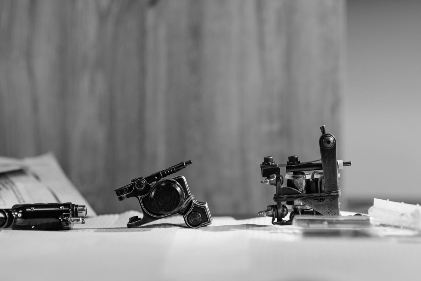 Vintage tattoo machines on a table in black and white