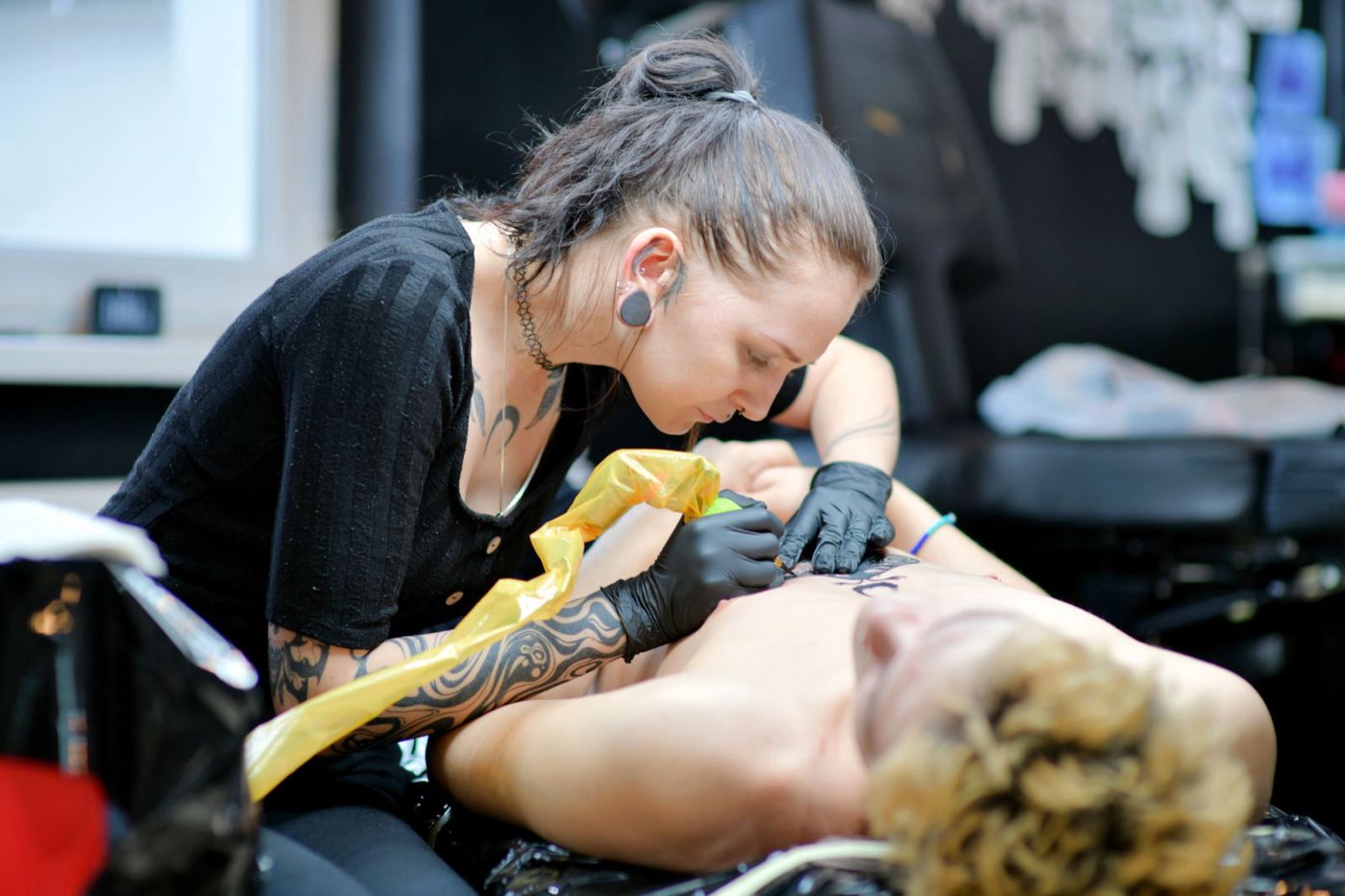 A tattoo session under the studio lamp